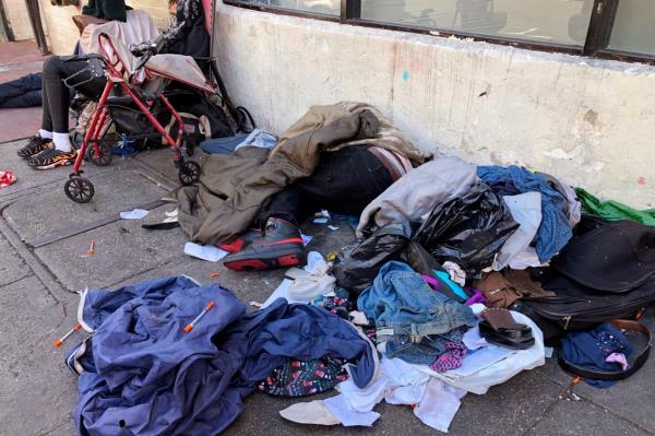 Homeless people sleeping on a sidewalk in San Francisco's Tenderloin neighborhood.