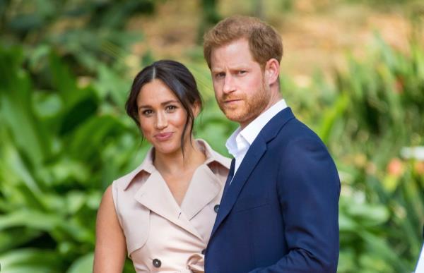 Prince Harry, Duke of Sussex, and Meghan, Duchess of Sussex, smiling and posing together, celebrating their 5th marriage anniversary