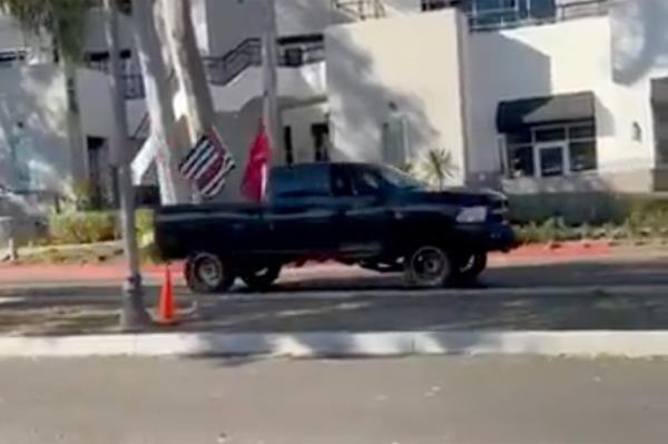 A black truck parked on the side of a road during the Mo<em></em>ntecito Trump Parade