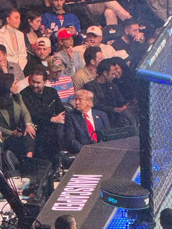 Trump sat in the front row of the UFC game surrounded by his recent cabinet nominees.
